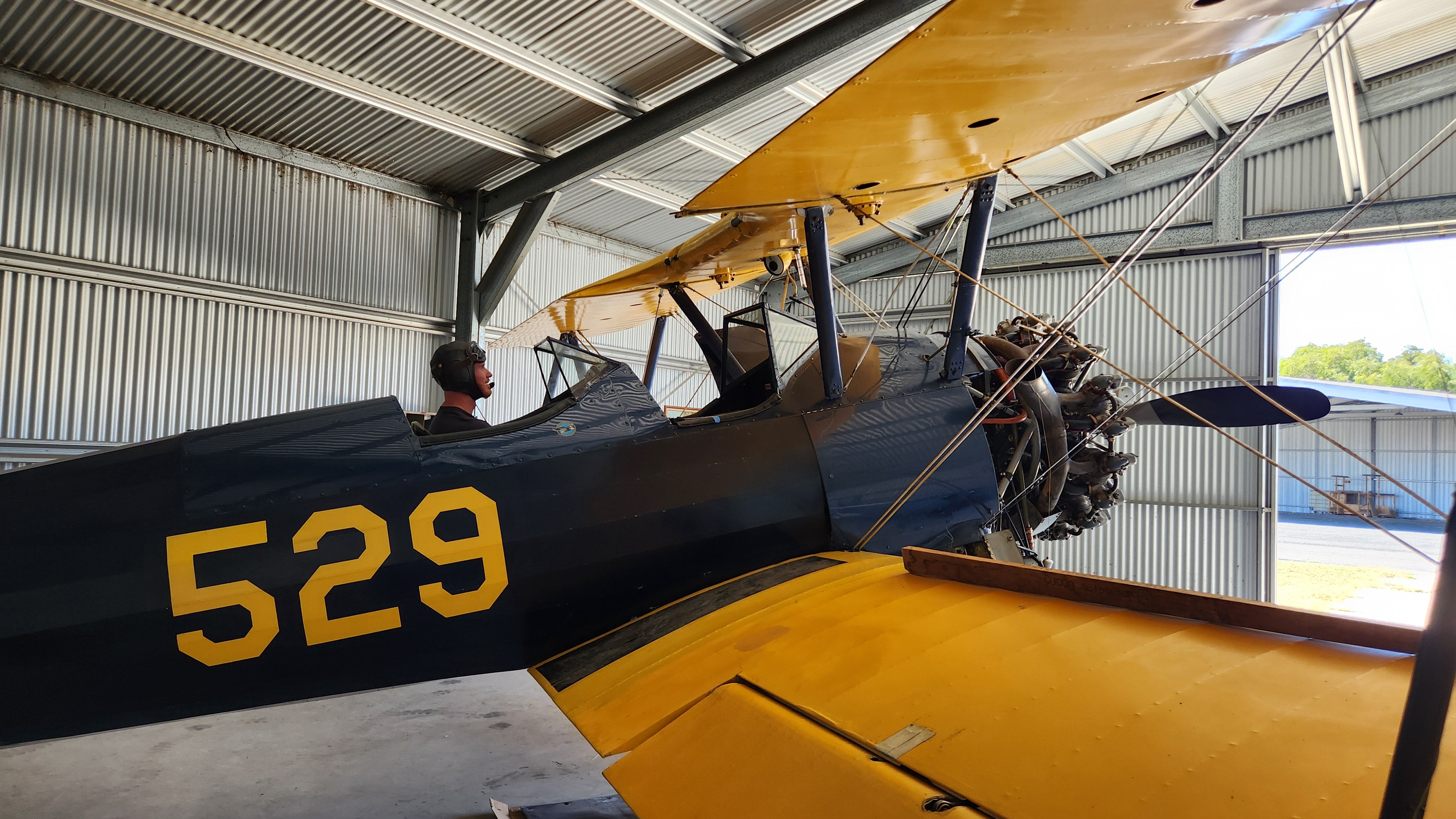 Pilot in Boeing Stearman Vintage Airplane in Bunbury Western Australia with helmet and goggles on