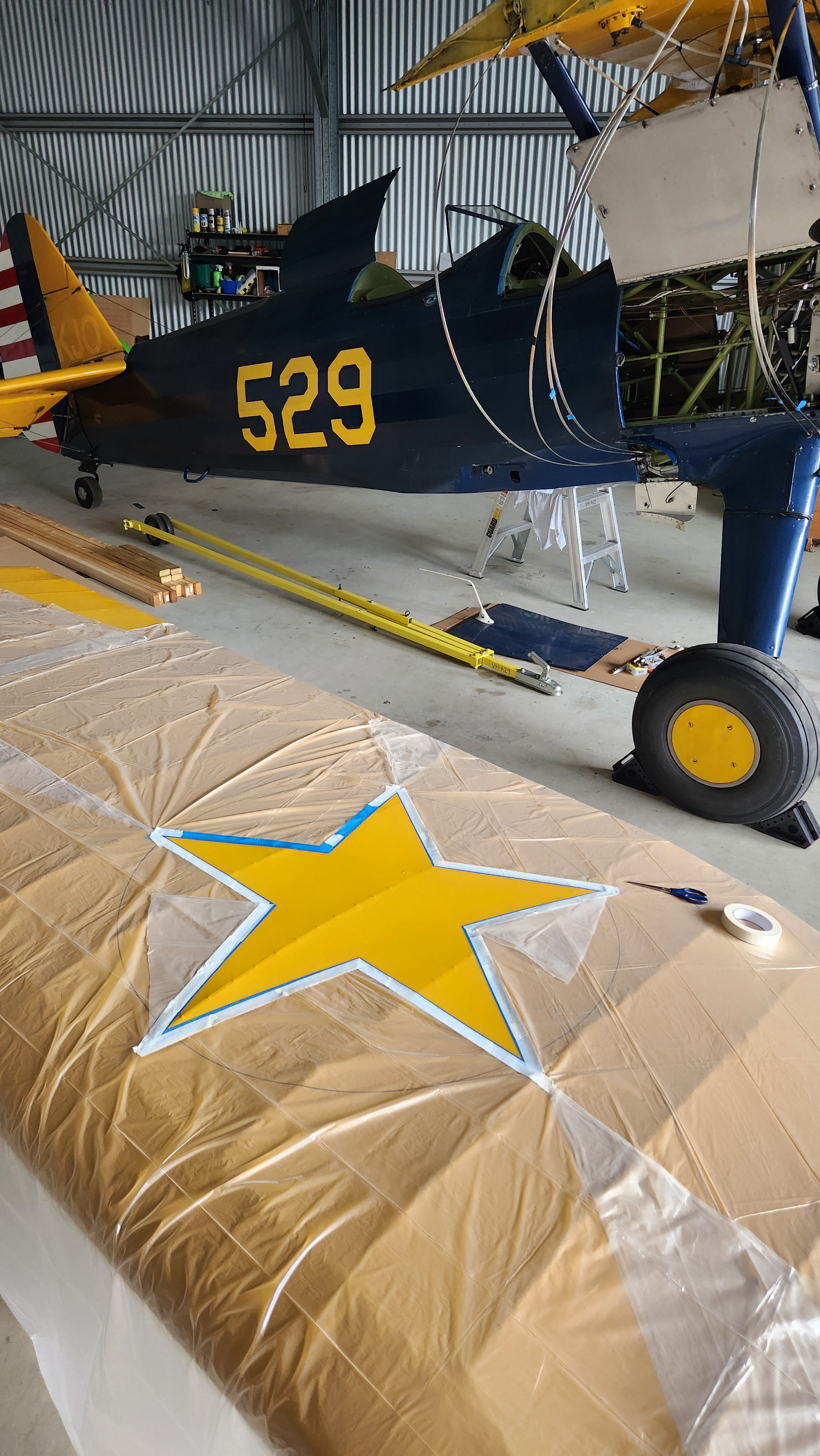Photo of Boeing Stearman wing getting masked up for painting of star for roundel.