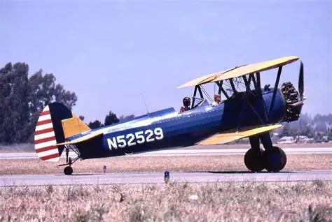 Biplane with a visible registration number on a runway
