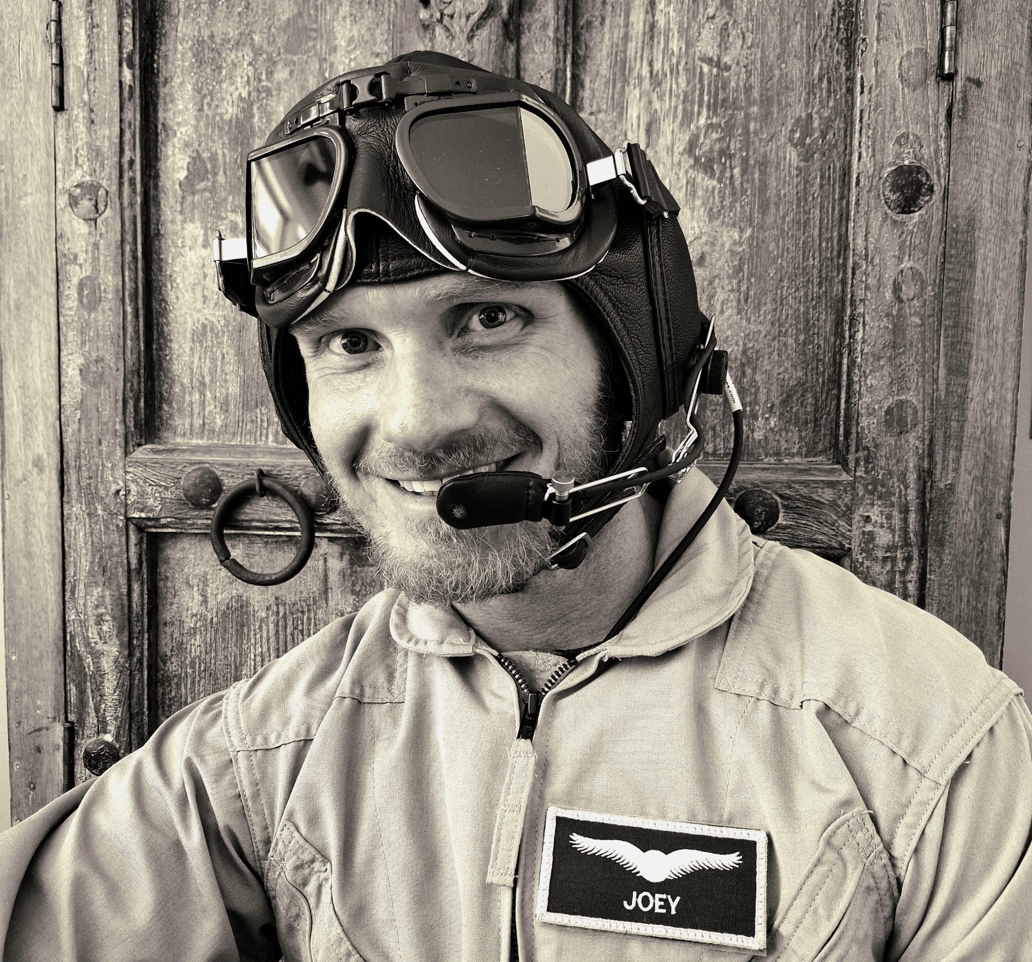 Portrait of Open Air Adventure Flights pilot Johan Strydom wearing a vintage leather flying helmet with aviation goggles